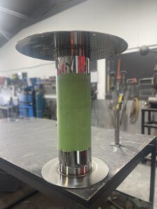 Stainless Steel Fabricator polishing a pedestal base in Auckland nz